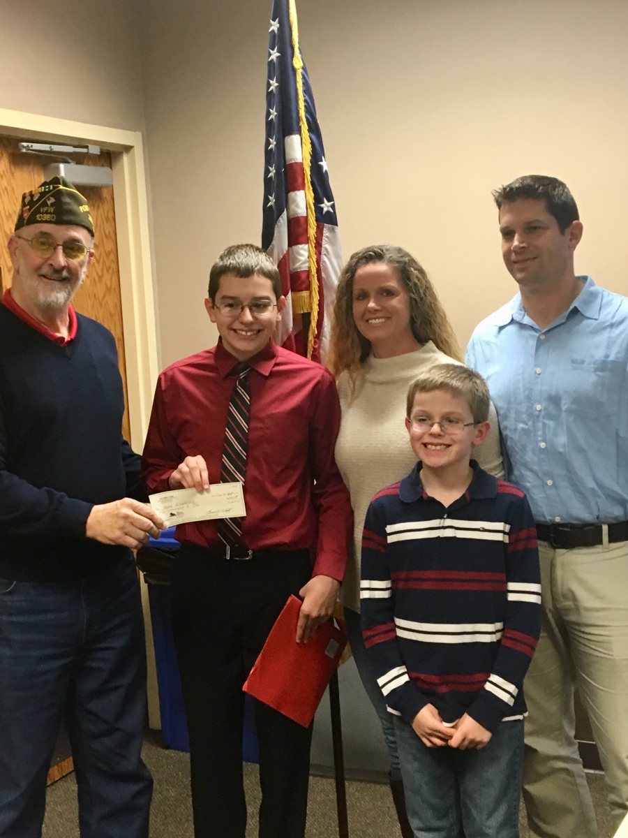 Mason and family receiving scholarship check
